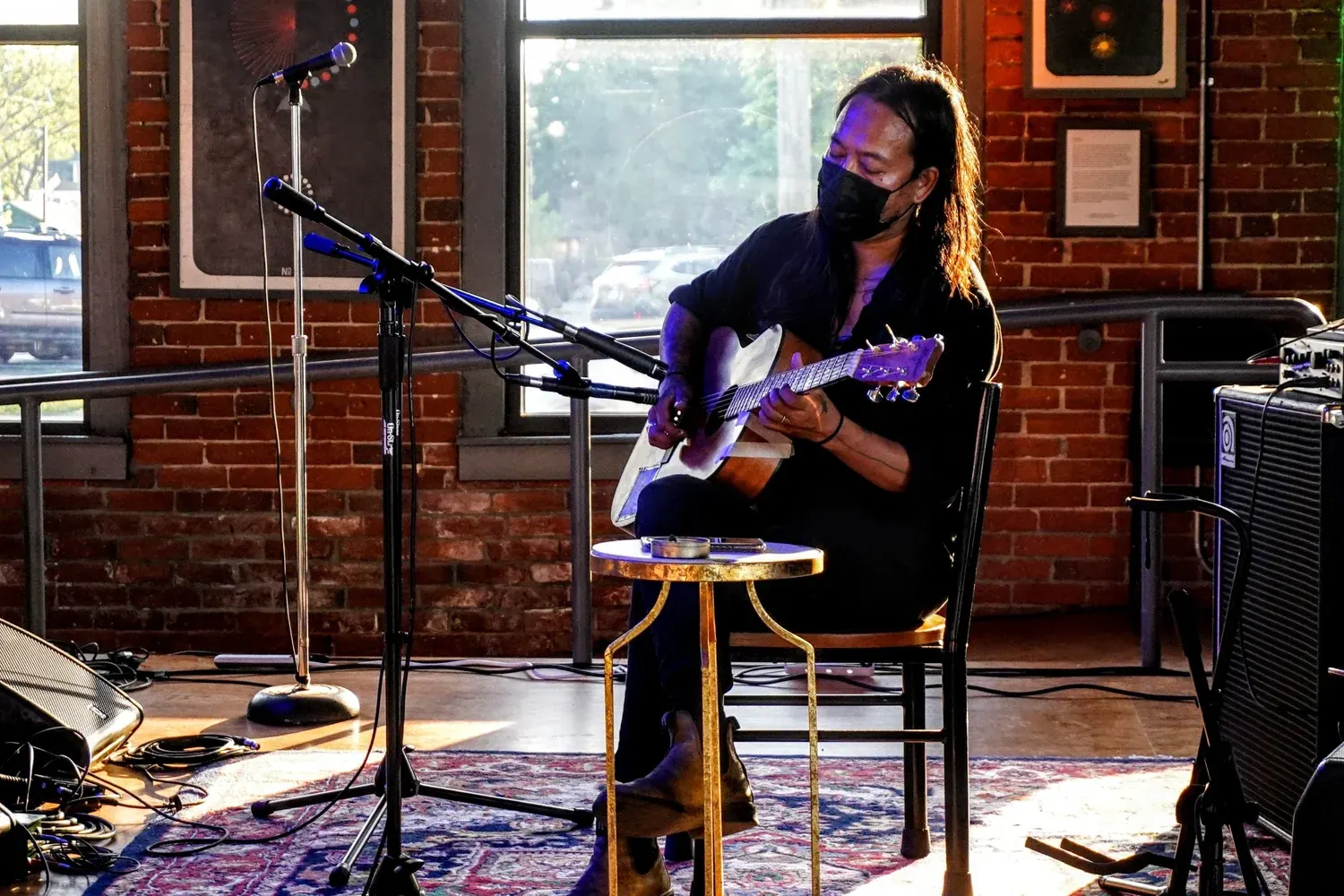 A guitarist playing by the window at Nova Arts